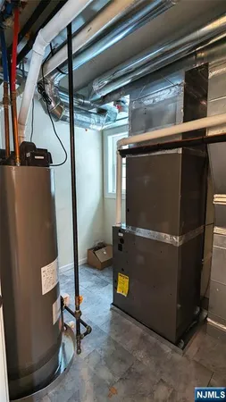 a view of a kitchen with cabinets stainless steel appliances wooden floor and a window