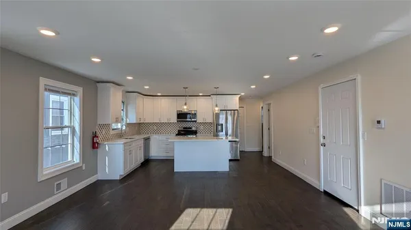 a kitchen with stainless steel appliances a refrigerator sink and stove