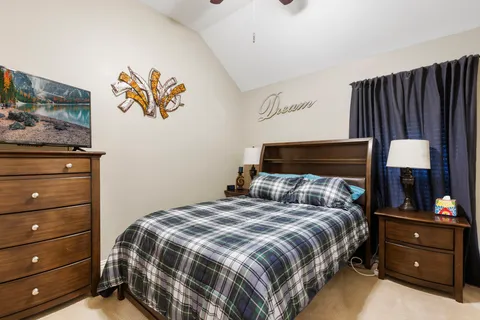 a bedroom with a bed and a television