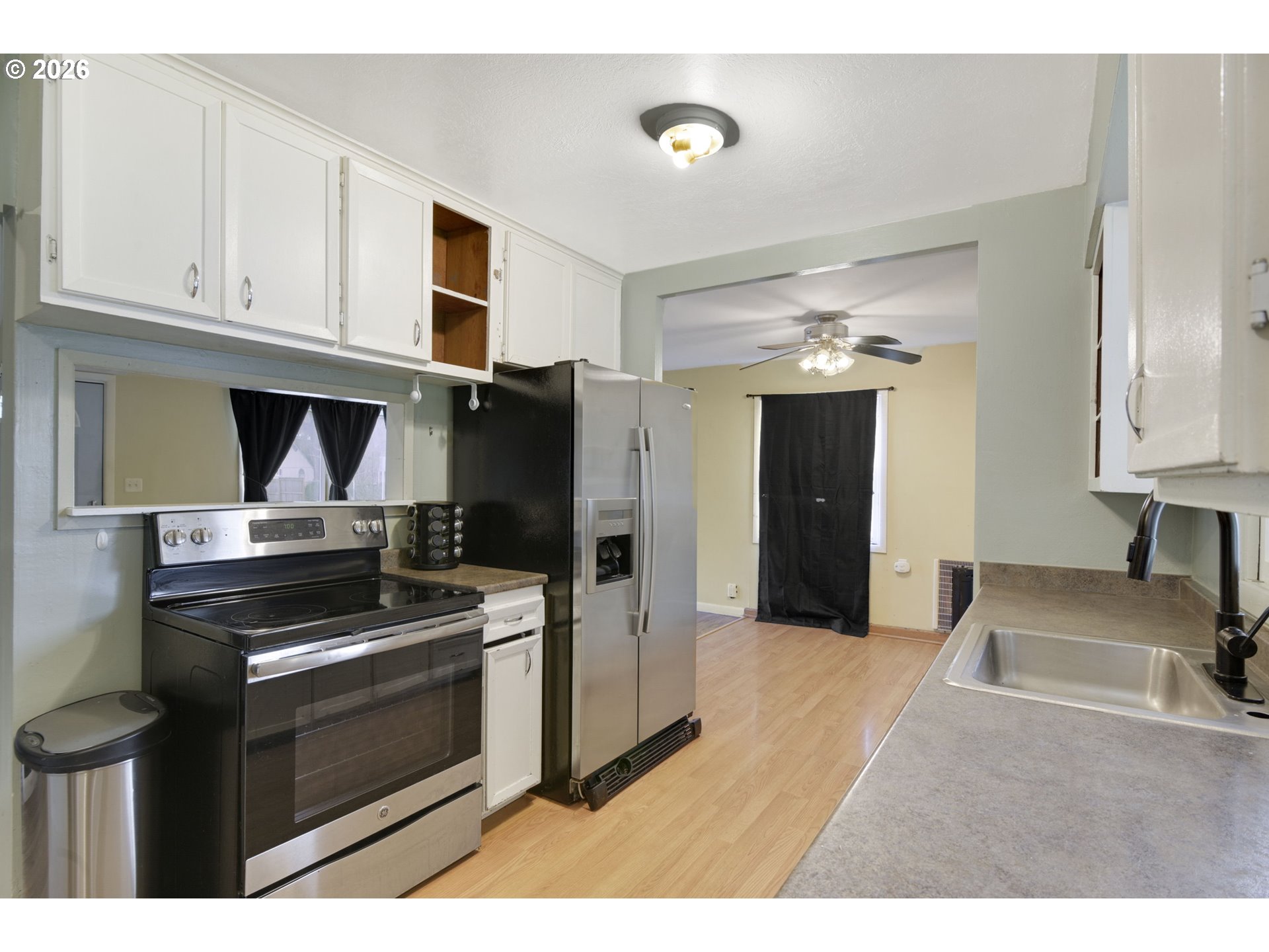106 North Lieser Road Vancouver, WA 98664 - Photo 13 of 36 a kitchen with stainless steel appliances a stove a microwave and a refrigerator