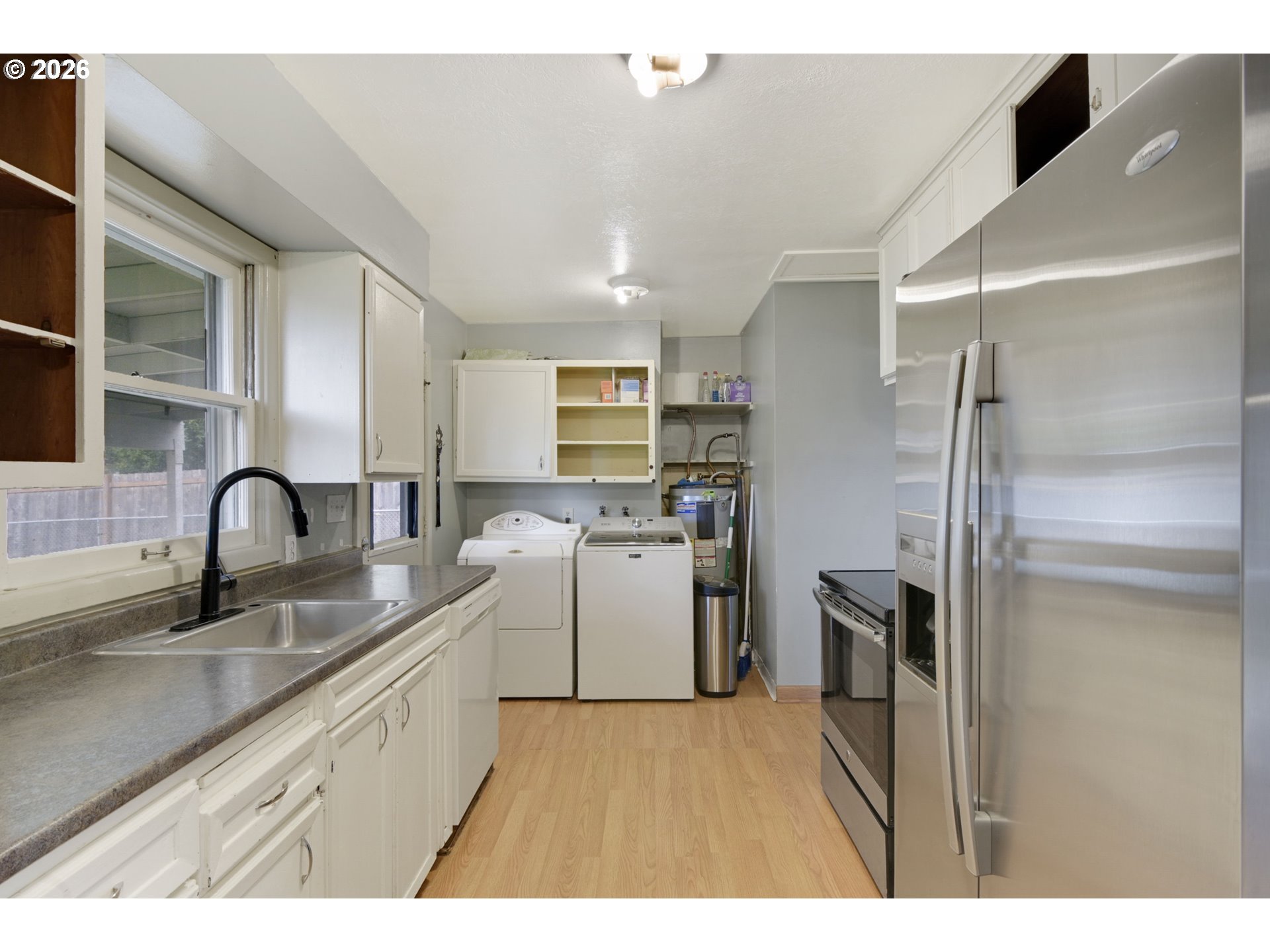 106 North Lieser Road Vancouver, WA 98664 - Photo 16 of 36 a kitchen with a sink stainless steel appliances and cabinets