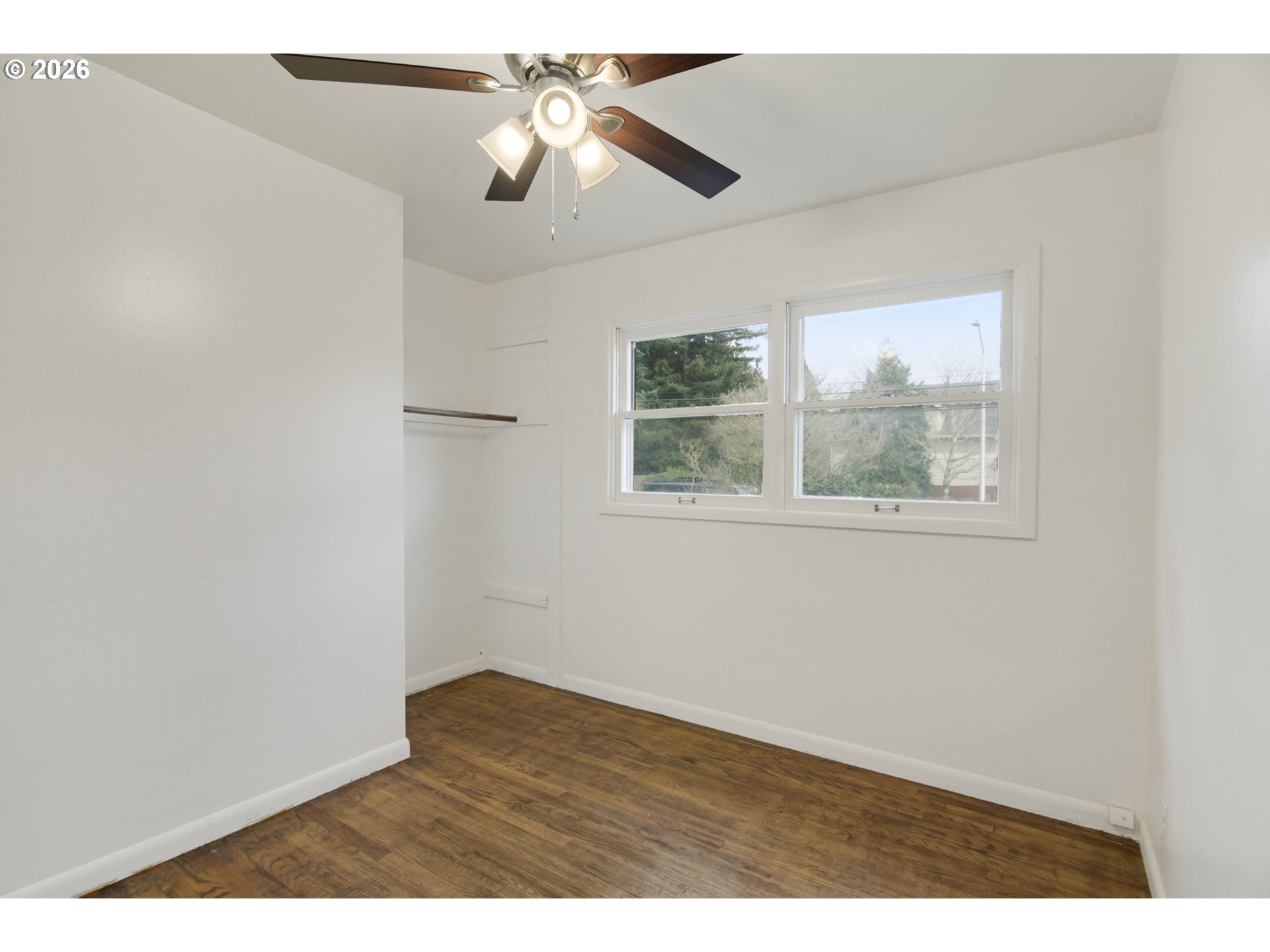 106 North Lieser Road Vancouver, WA 98664 - Photo 23 of 36 an empty room with wooden floor fan and windows