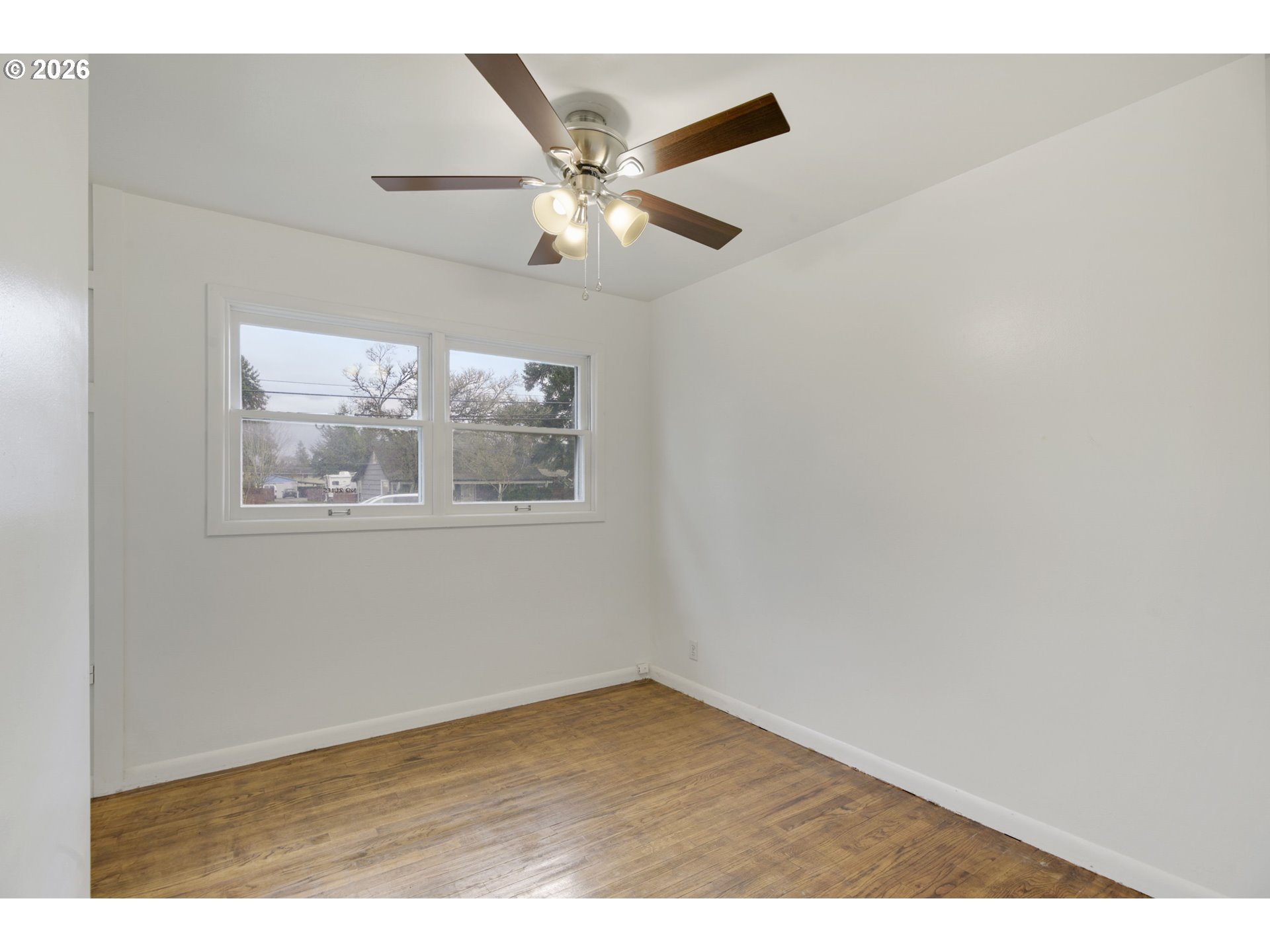 106 North Lieser Road Vancouver, WA 98664 - Photo 25 of 36 an empty room with wooden floor and ceiling fan