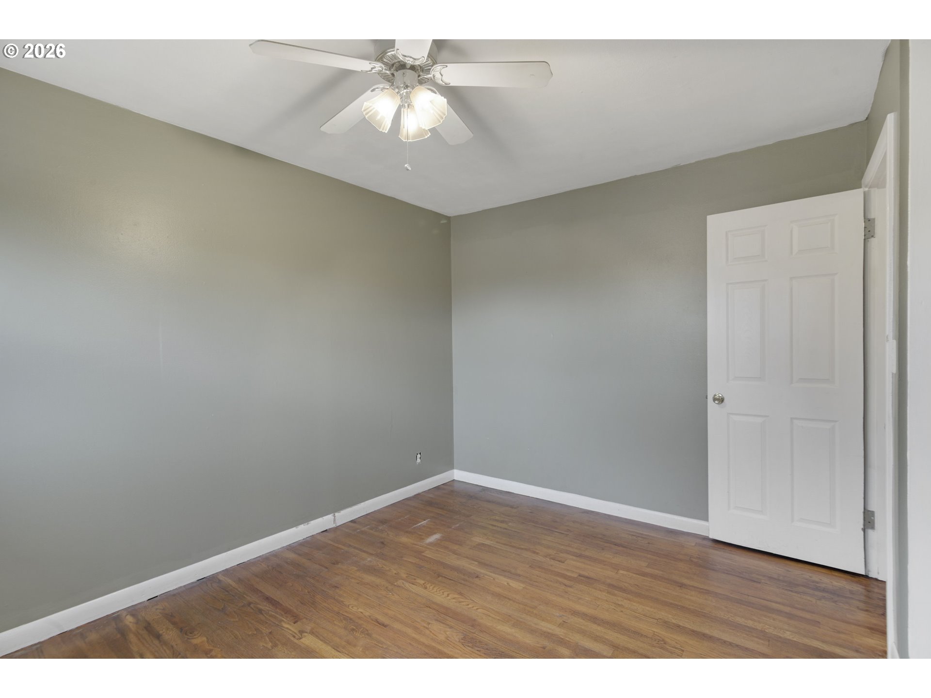106 North Lieser Road Vancouver, WA 98664 - Photo 31 of 36 an empty room with a chandelier fan and wooden floor