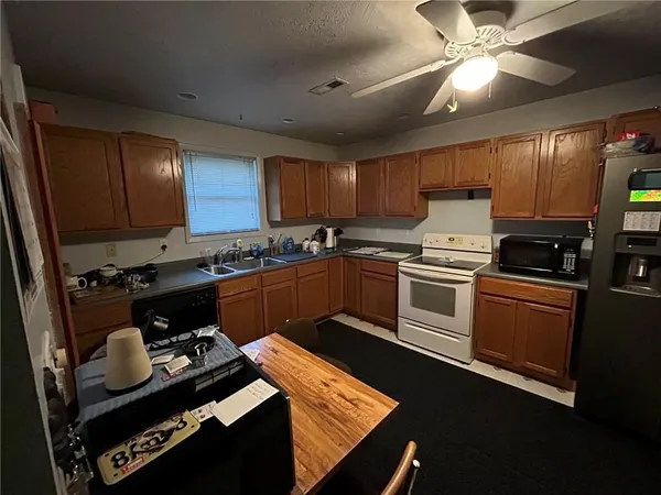 a kitchen with a stove a sink and a refrigerator