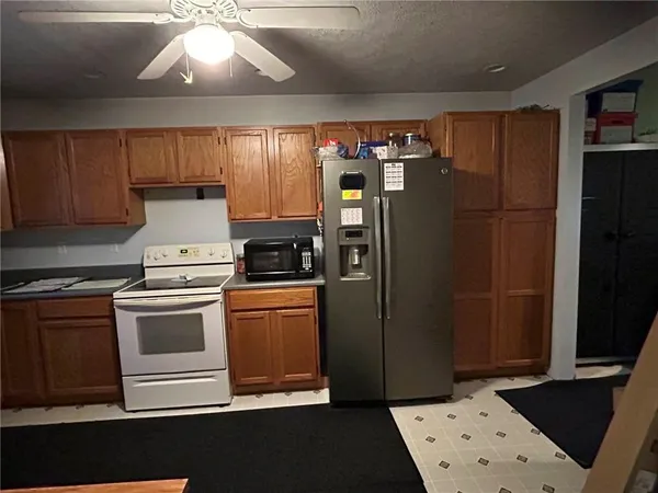 a kitchen with stainless steel appliances a refrigerator stove and sink