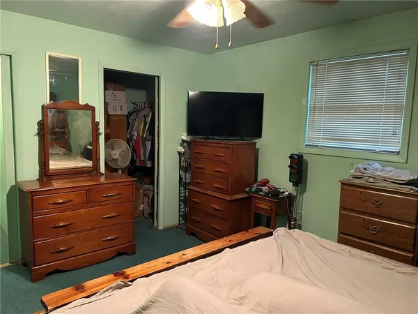 a room with a bed and a television