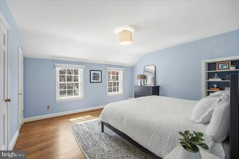 a bedroom with a bed and glass door