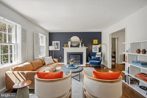 a living room with a fireplace wooden floor and a couch