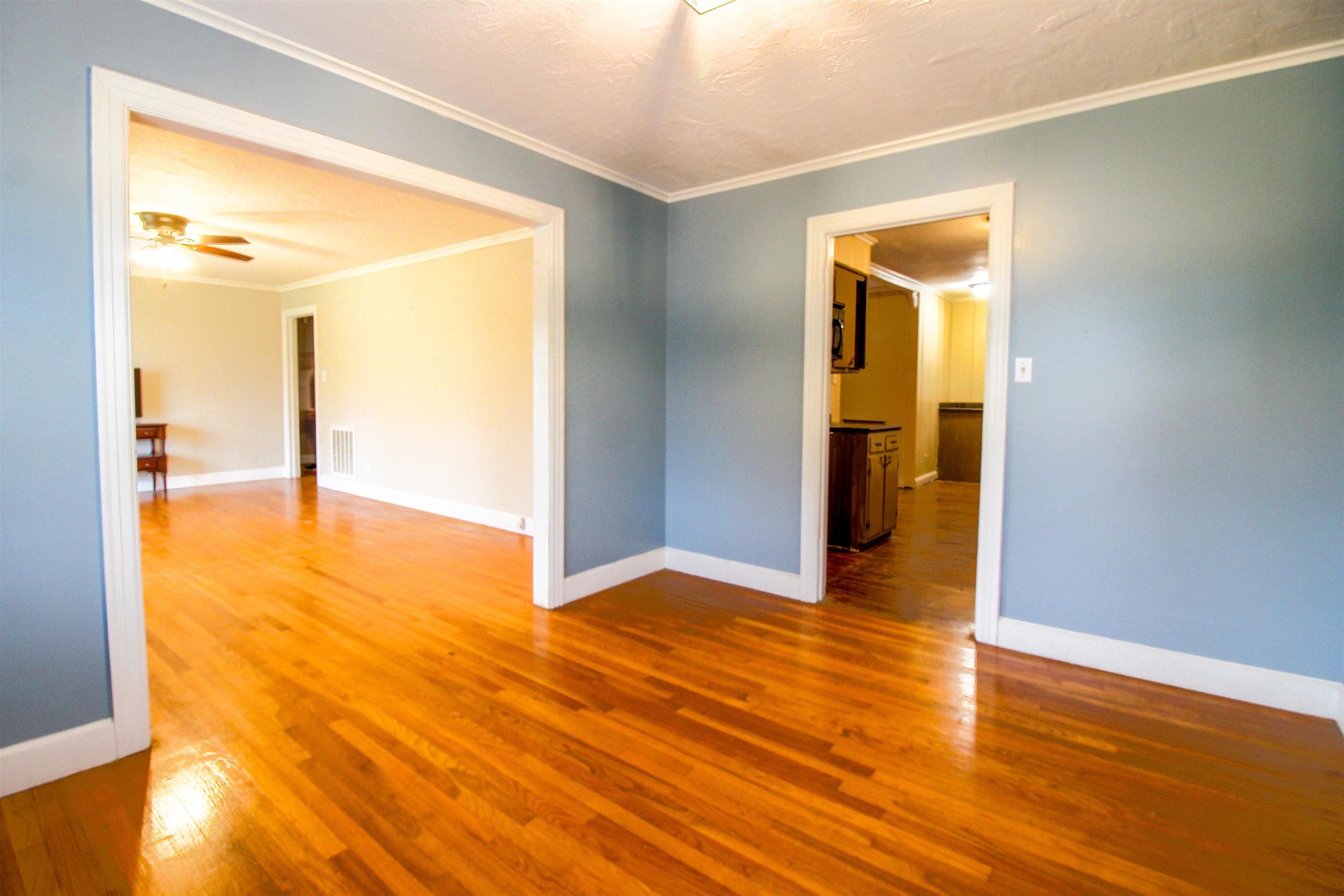 4075 Arp Central Road Ripley, TN 38063 - Photo 11 of 37 Formal Dining Room with Original Hardwood floors a textured ceiling, and ornamental molding.