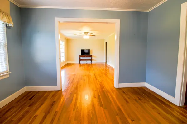 a view of a room with wooden floor and a sink