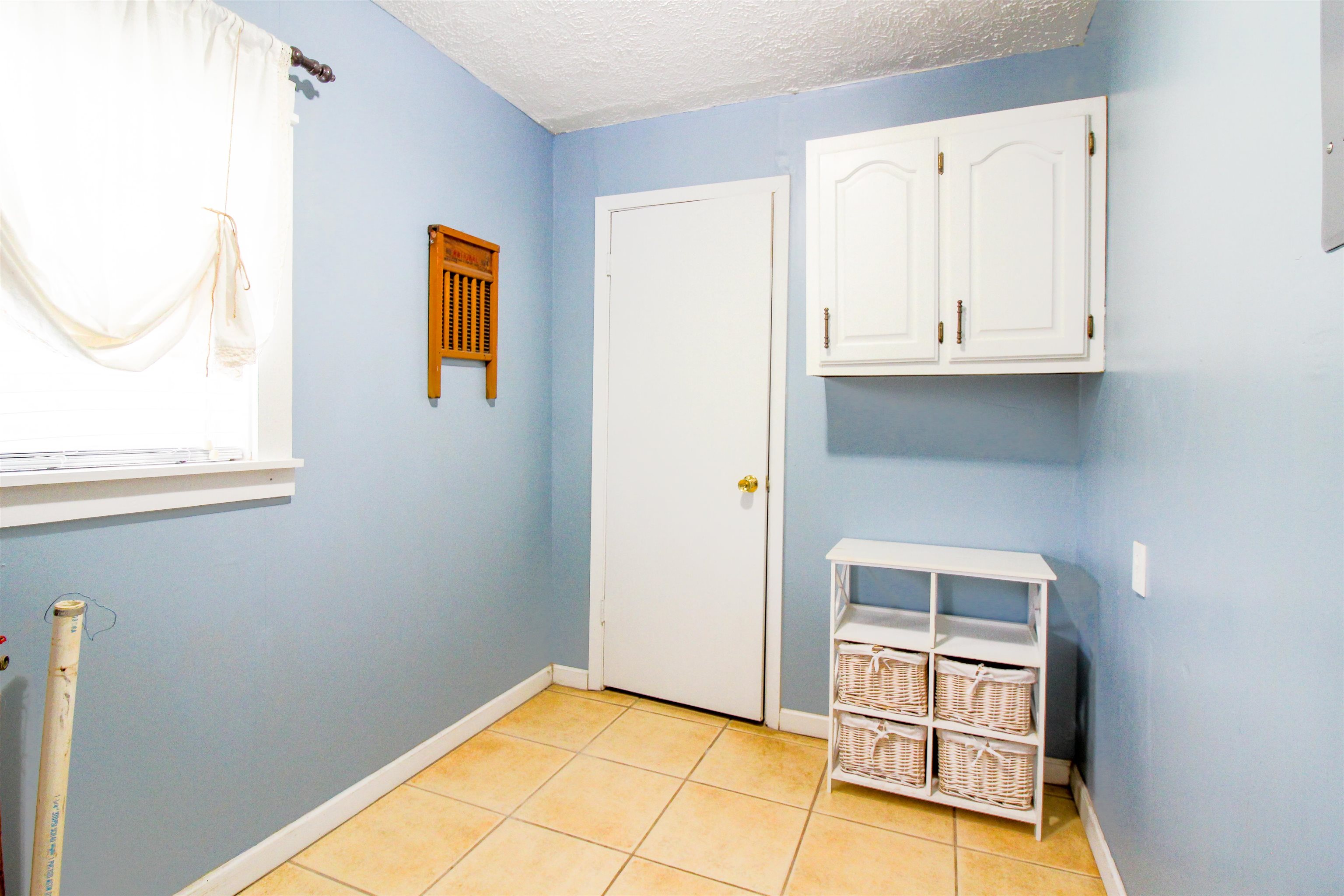 4075 Arp Central Road Ripley, TN 38063 - Photo 19 of 37 Laundry area with a textured ceiling and light tile patterned floors
