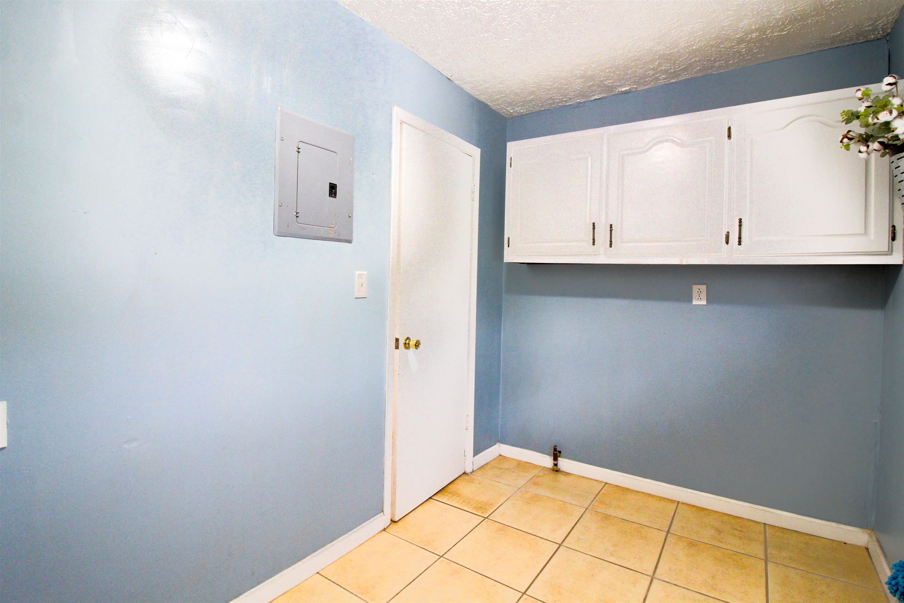 4075 Arp Central Road Ripley, TN 38063 - Photo 20 of 37 Laundry room a textured ceiling, light tile patterned floors, and cabinet space