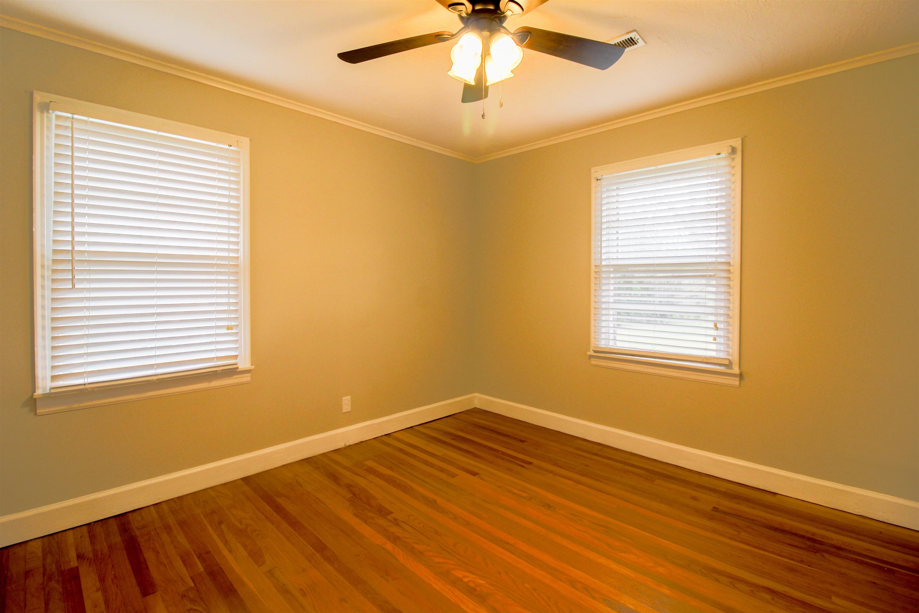 4075 Arp Central Road Ripley, TN 38063 - Photo 27 of 37 Bedroom 2 with Original Hardwood floors, ornamental molding, and a ceiling fan.