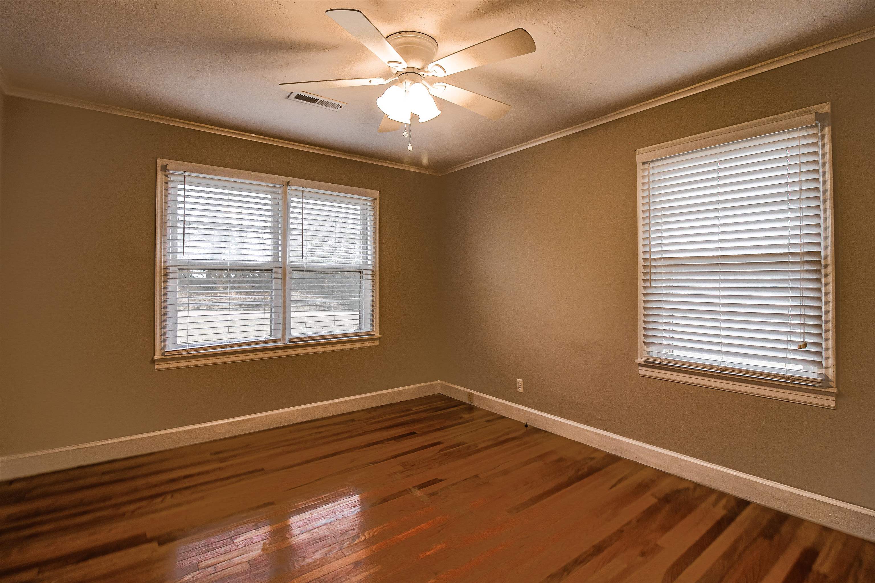 4075 Arp Central Road Ripley, TN 38063 - Photo 29 of 37 Bedroom 3 with Original Hardwood floors, ornamental molding, and a ceiling fan.