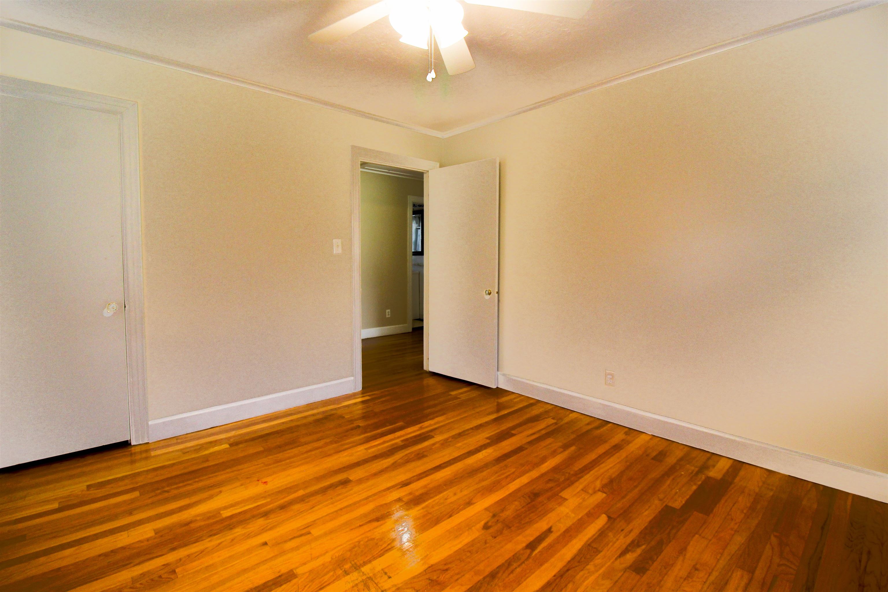 4075 Arp Central Road Ripley, TN 38063 - Photo 30 of 37 Bedroom 3 with Original Hardwood floors, ornamental molding, and a ceiling fan.