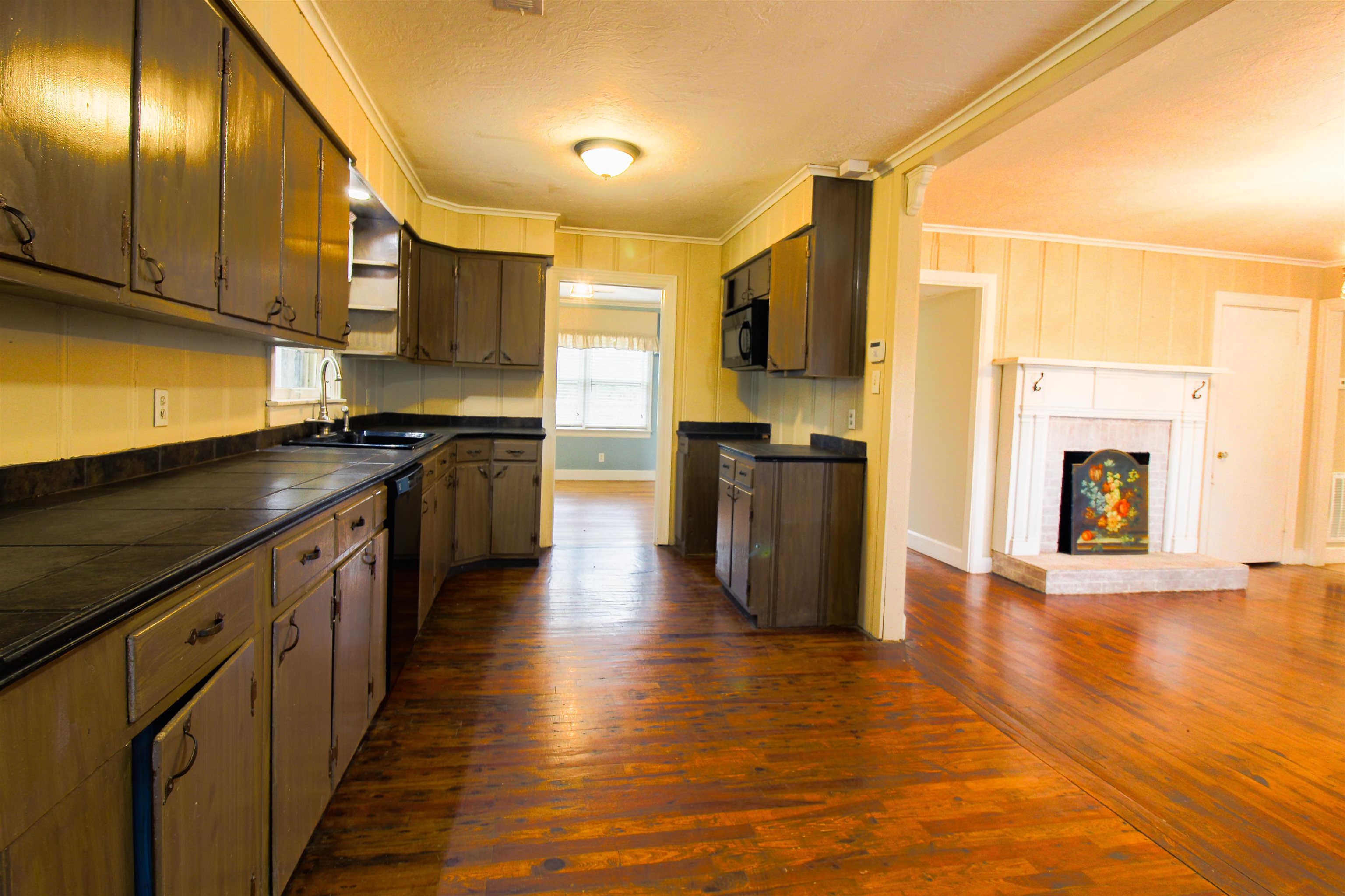 4075 Arp Central Road Ripley, TN 38063 - Photo 5 of 37 Kitchen with ornamental molding, dark wood-style flooring, tile counters.
