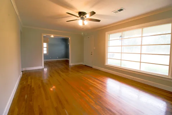 wooden floor in an empty room with a window