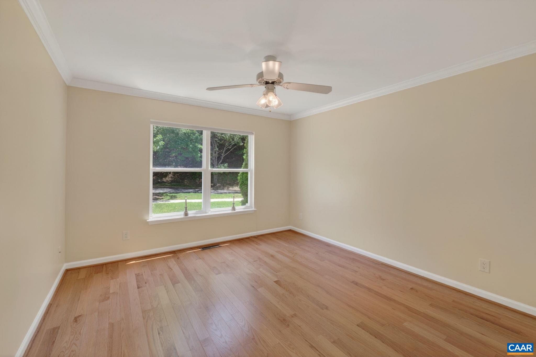 590 Mockingbird Way Charlottesville, VA 22901 - Photo 6 of 43 a view of an empty room with wooden floor and a window
