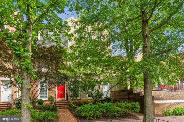 a front view of a house with a tree