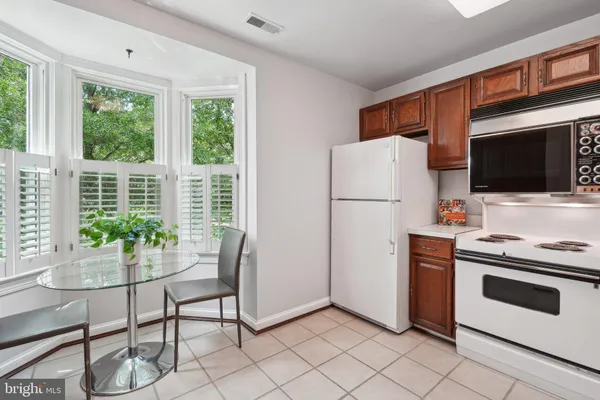 a kitchen with stainless steel appliances a stove a refrigerator and a fireplace