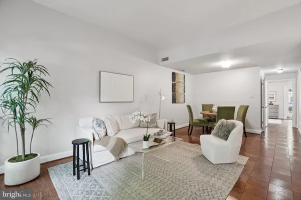 a living room with furniture potted plant and a table