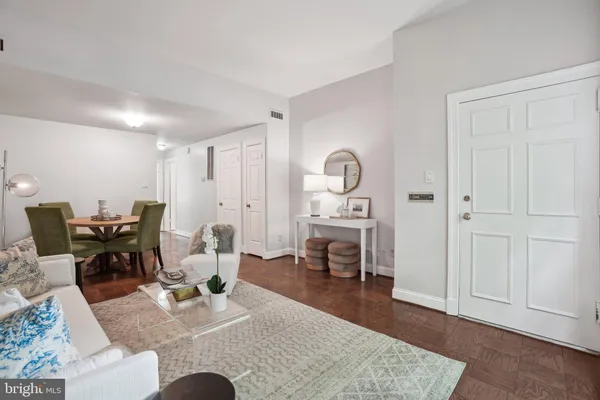 a living room with furniture rug and wooden floor
