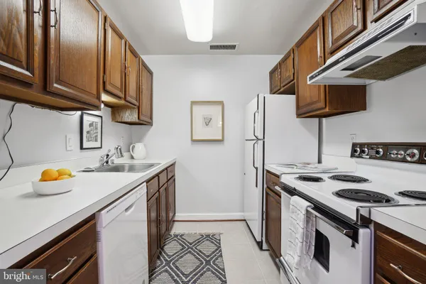 a kitchen with stainless steel appliances granite countertop a stove and a sink