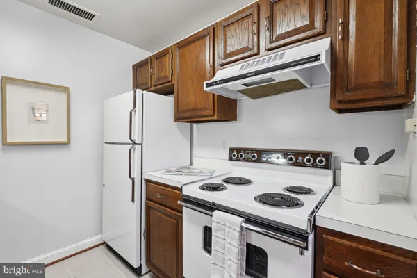 a kitchen with a stove and a refrigerator