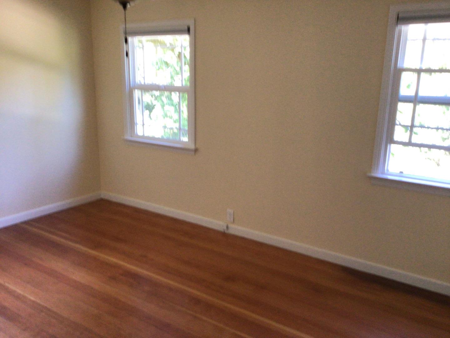 650 Whiskey Hill Road, Unit INLAW Woodside, CA 94062 - Photo 5 of 8 an empty room with wooden floor and windows