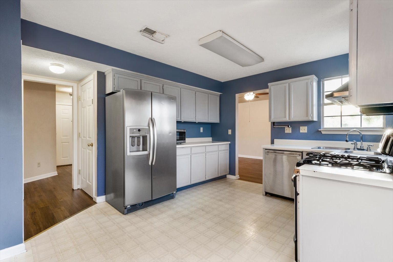 853 Bishopsgate Road Antioch, TN 37013 - Photo 9 of 41 a kitchen with stainless steel appliances granite countertop a stove a refrigerator and a sink
