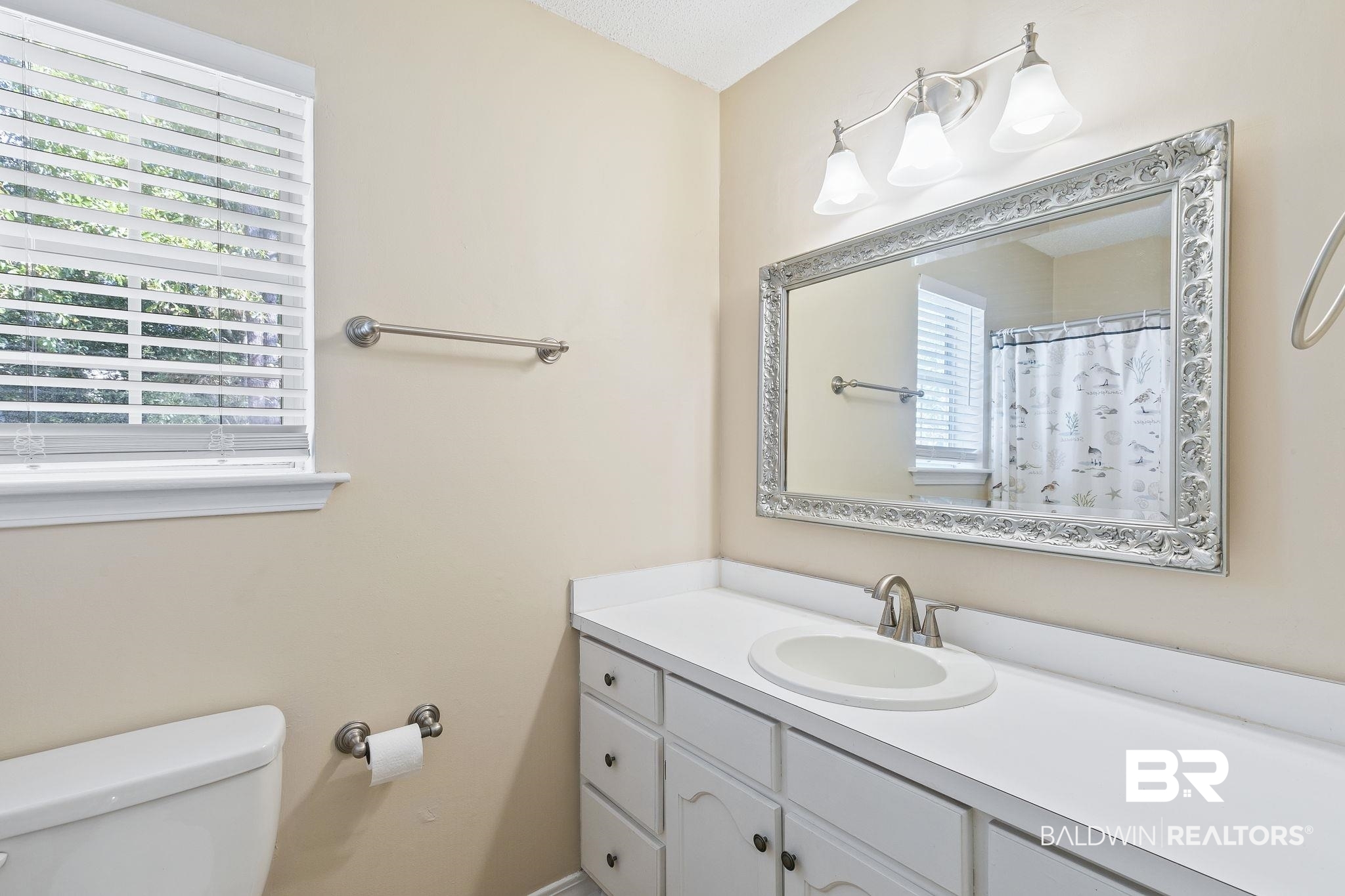 359 Ridgewood Drive Daphne, AL 36526 - Photo 40 of 73 Bathroom featuring a wealth of natural light, vanity, a textured ceiling, and toilet