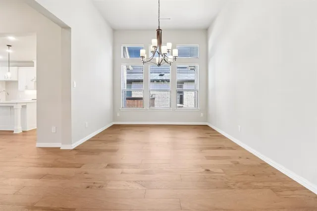 a view of a room with wooden floor and large windows