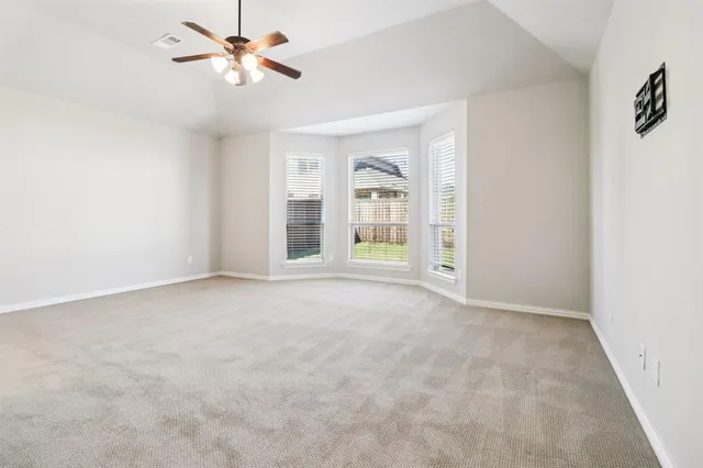 a view of an empty room with a ceiling fan