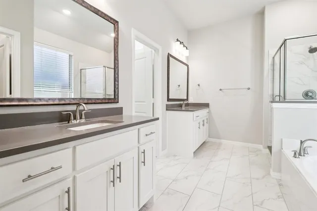 a spacious bathroom with a sink double vanity and a mirror