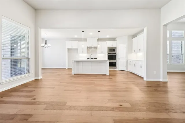 a view of kitchen with wooden floor and window