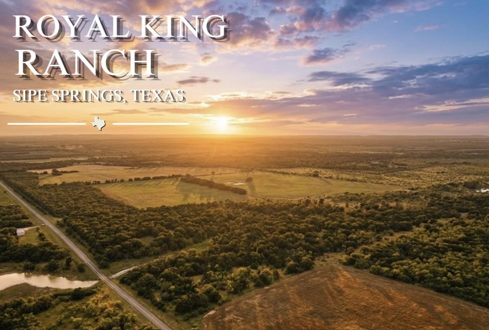 3976 Fm 1477 Comanche, TX 76442 - Photo 1 of 11 Expansive rural landscape featuring a roadway, mature tree coverage, open fields, and natural water features under a vibrant sky