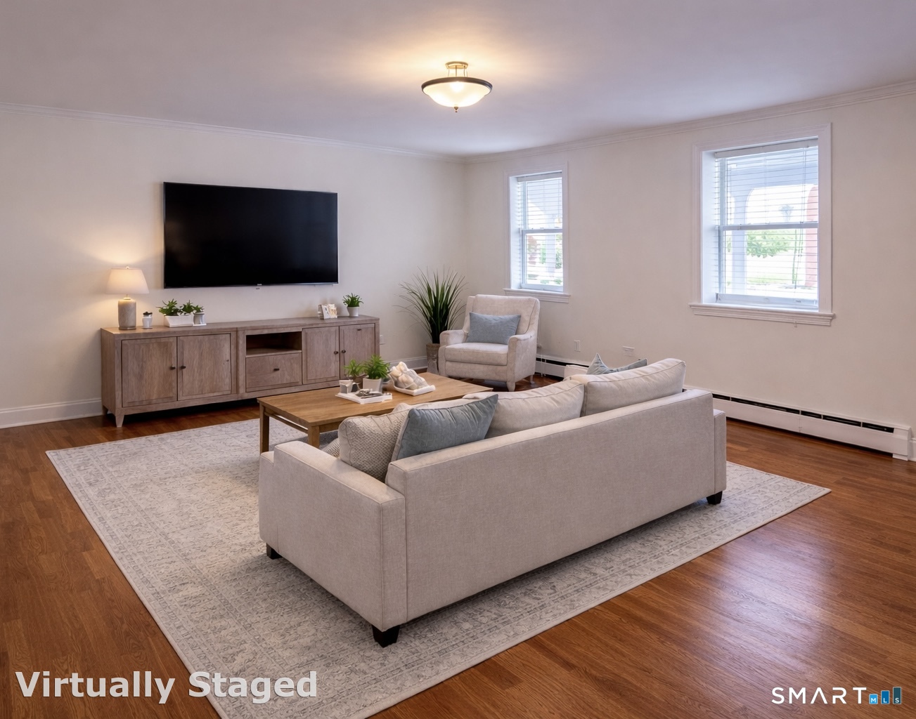391 Reef Road, Unit 1A Fairfield, CT 06824 - Photo 2 of 24 a living room with furniture and a flat screen tv
