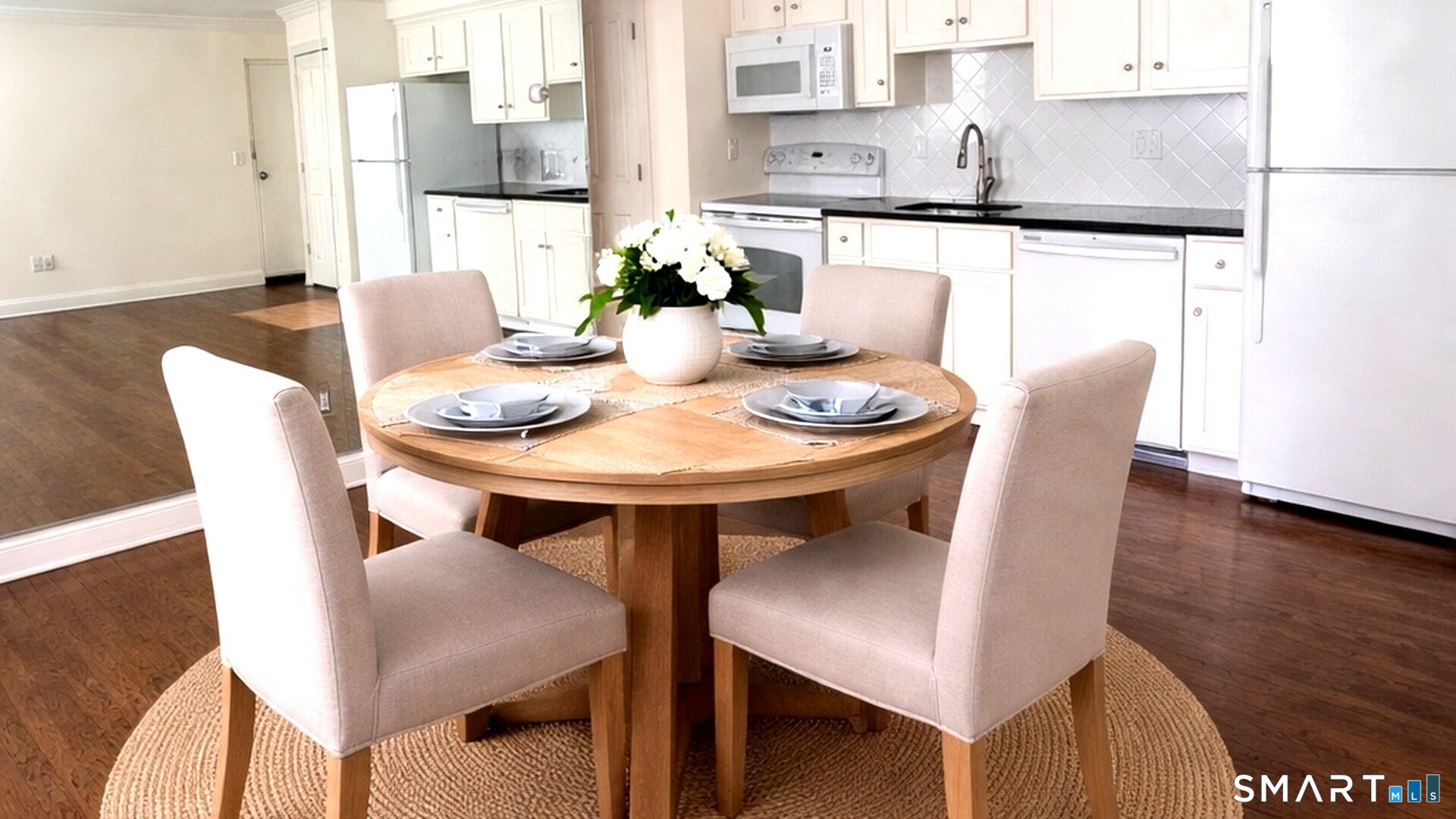 391 Reef Road, Unit 1A Fairfield, CT 06824 - Photo 24 of 24 a view of a dining room with furniture and wooden floor
