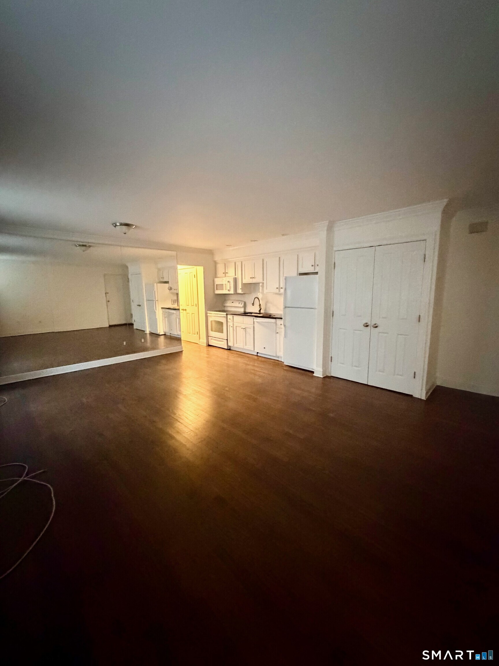 391 Reef Road, Unit 1A Fairfield, CT 06824 - Photo 4 of 24 a view of empty room with wooden floor