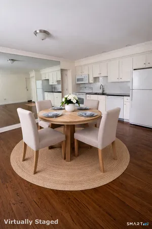 a dining room with furniture a rug and wooden floor