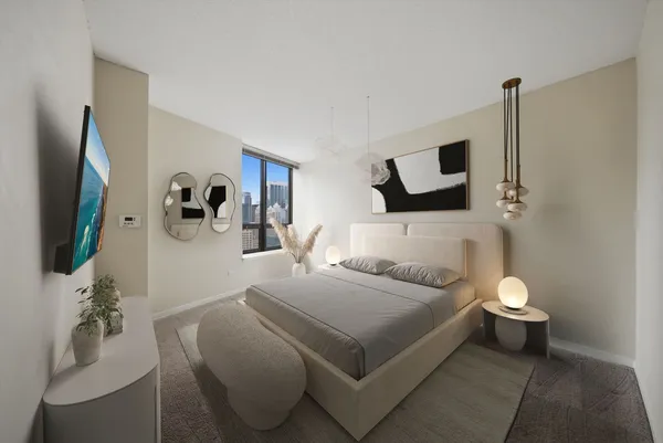 a bedroom with a bed and a flat screen tv