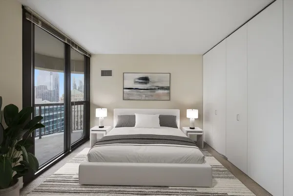 a bedroom with a large bed and a large window