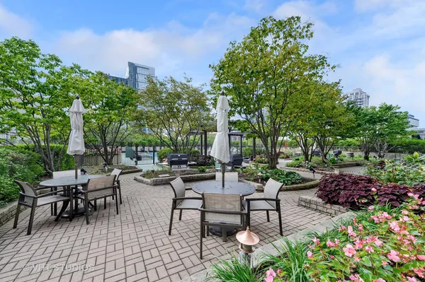 a view of a patio with a table and chairs and potted plants