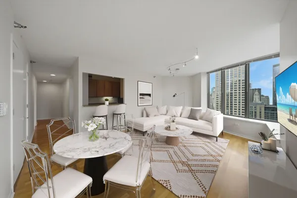a living room with couches a coffee table and a flat screen tv