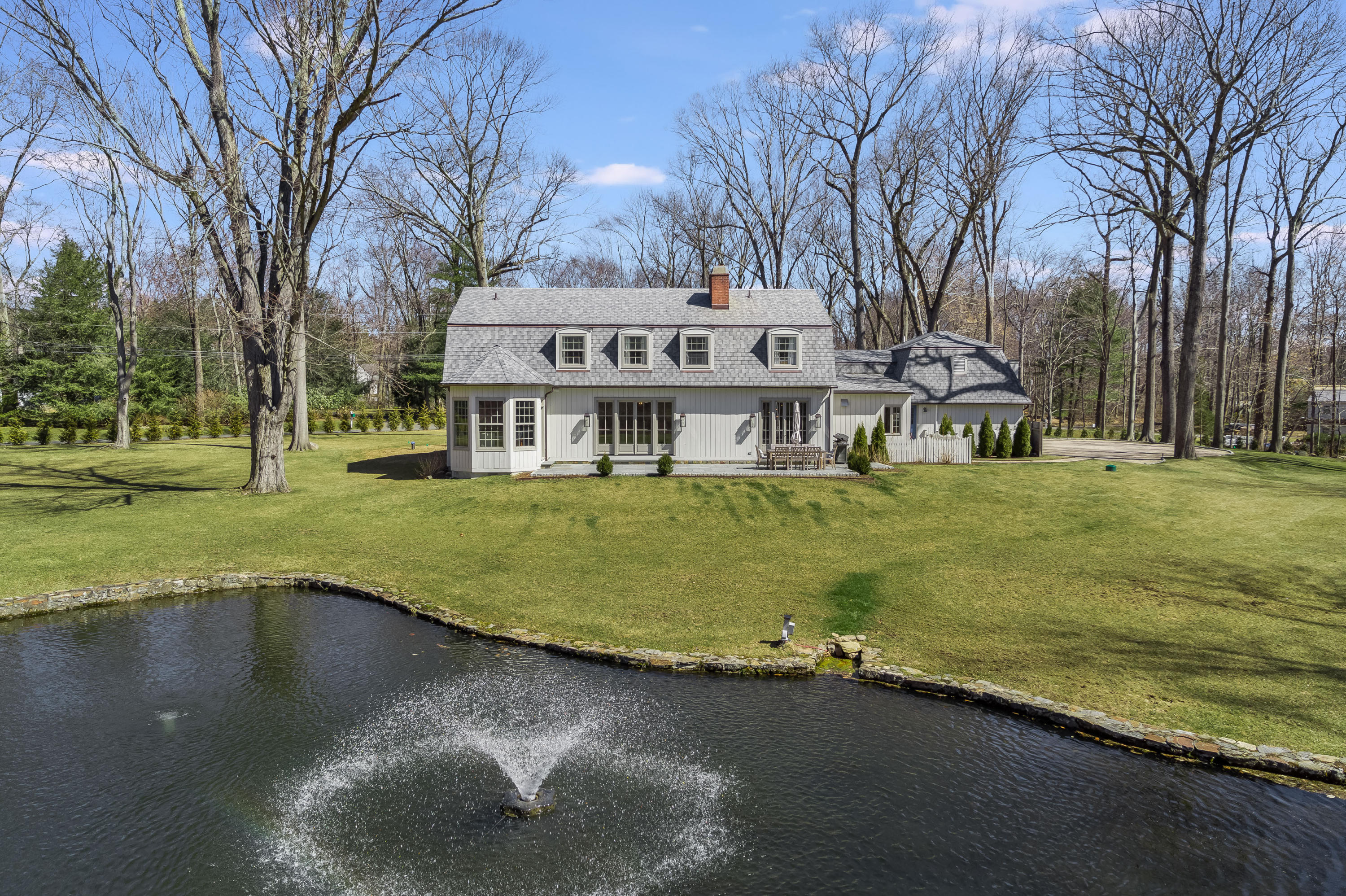 15 Indian Spring Trail Darien, CT 06820 - Photo 6 of 37 a view of a house with a yard and sitting area