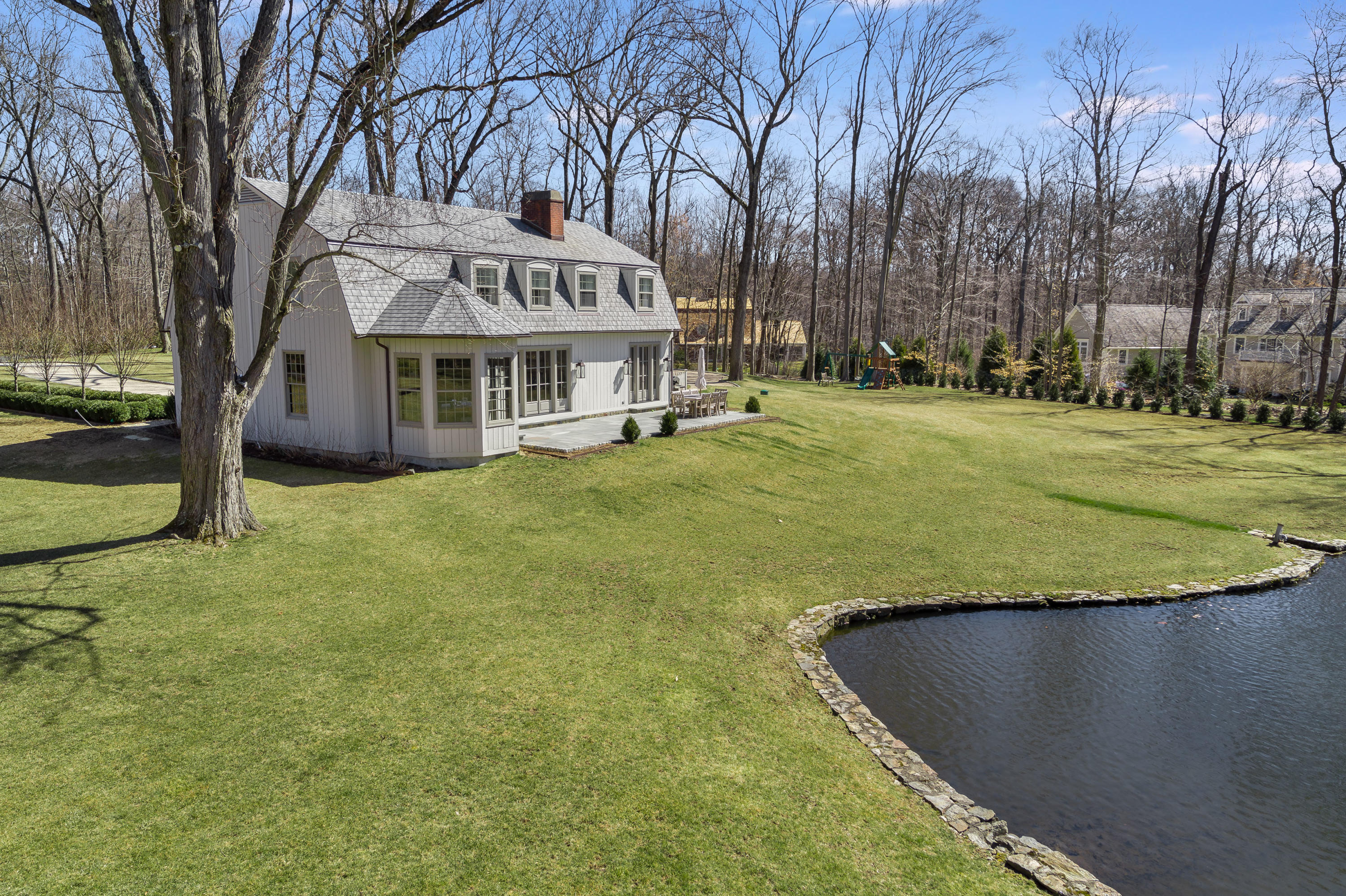 15 Indian Spring Trail Darien, CT 06820 - Photo 8 of 37 a view of a house with a yard and trees