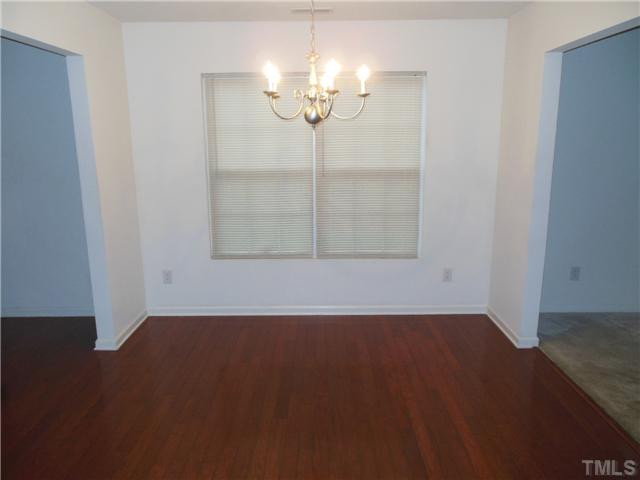 2046 Spring Creek Drive Durham, NC 27704 - Photo 2 of 10 a view of a room with wooden floor and chandelier