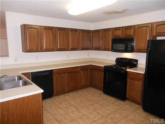 2046 Spring Creek Drive Durham, NC 27704 - Photo 3 of 10 a kitchen with a sink and cabinets