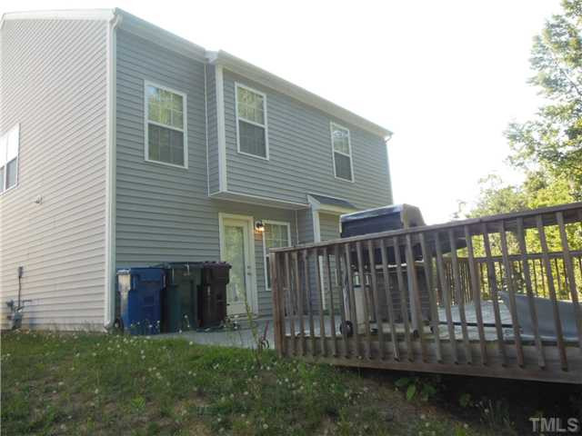 2046 Spring Creek Drive Durham, NC 27704 - Photo 10 of 10 a view of a house with a small yard and wooden fence